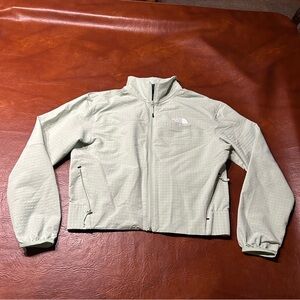 The North face green wind breaker kinda material.